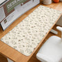 Desk mat with a sage green background, tiny wildflowers, and a vintage botanical floral pattern.