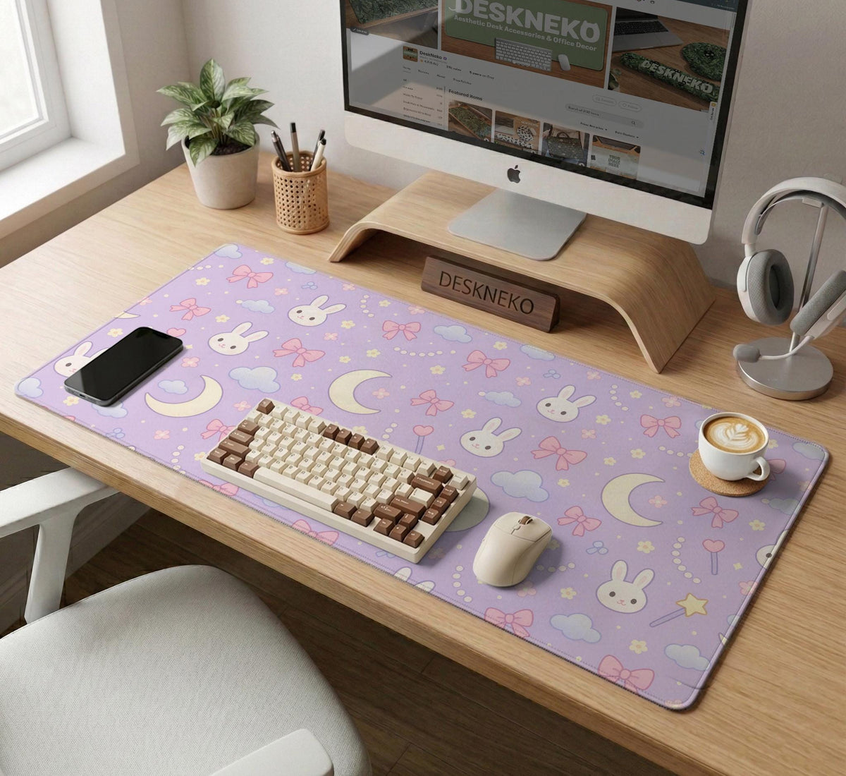 Lavender desk mat with an all-over pattern of bunny faces, clouds, moons, bows, and flowers in pastel colors.