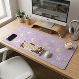 Lavender desk mat with an all-over pattern of bunny faces, clouds, moons, bows, and flowers in pastel colors.