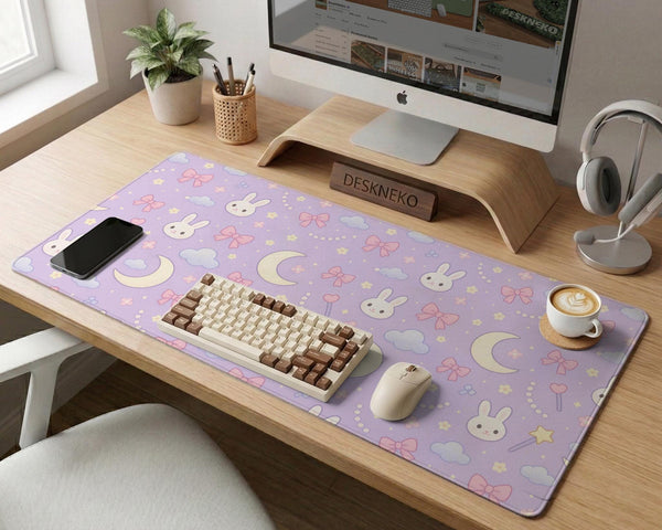 Lavender desk mat with an all-over pattern of bunny faces, clouds, moons, bows, and flowers in pastel colors.
