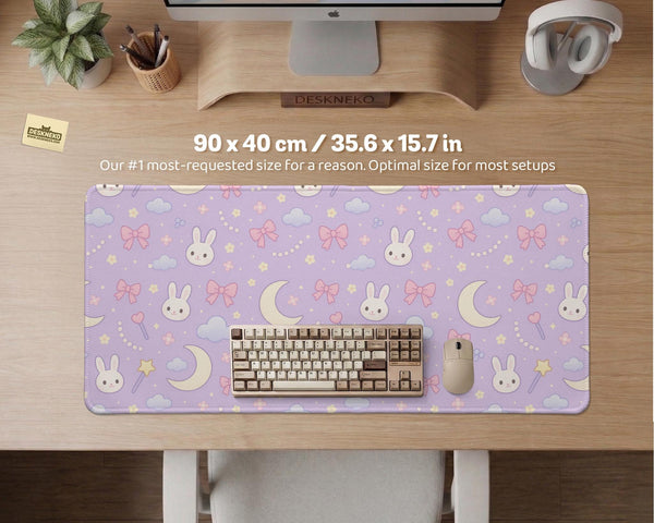 Pastel lavender desk mat with an all-over pattern of bunnies, crescent moons, clouds, bows, stars, and small flowers.
