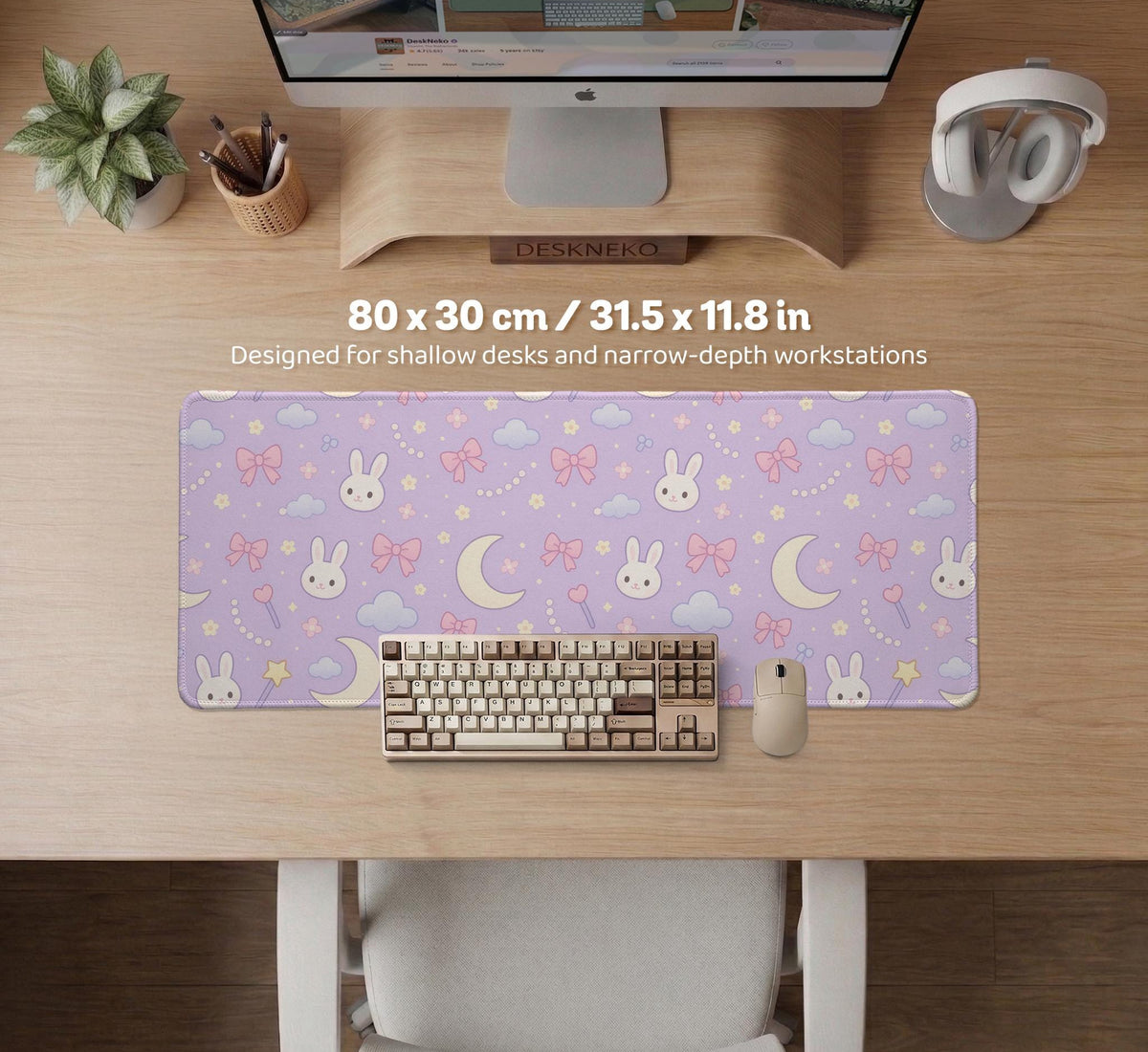 Lavender desk mat with an all-over pattern of bunny faces, clouds, moons, bows, and flowers in pastel colors.