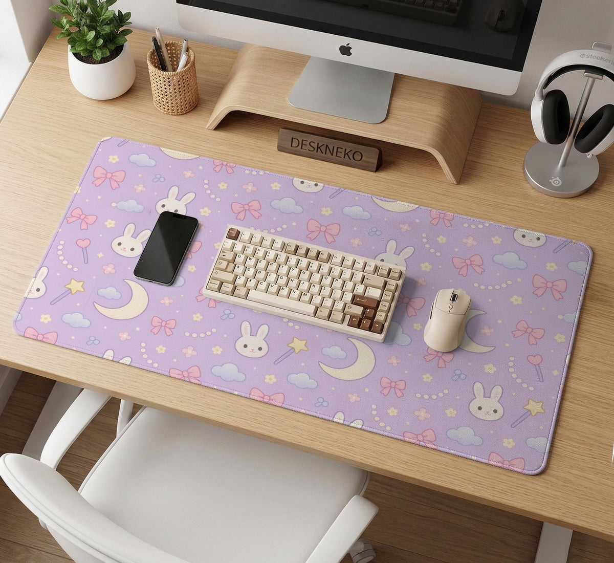 Pastel lavender desk mat with an all-over pattern of bunnies, crescent moons, clouds, bows, stars, and small flowers.