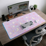 Pastel lavender desk mat with an all-over pattern of bunnies, crescent moons, clouds, bows, stars, and small flowers.