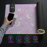 Lavender desk mat with an all-over pattern of bunny faces, clouds, moons, bows, and flowers in pastel colors.