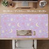 Lavender desk mat with an all-over pattern of bunny faces, clouds, moons, bows, and flowers in pastel colors.