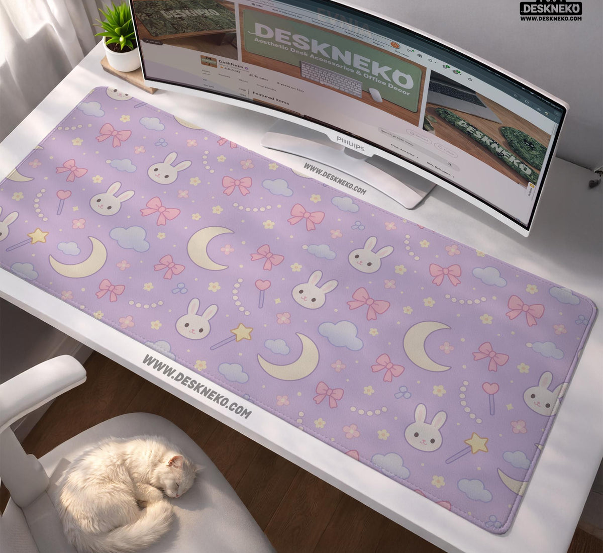 Lavender desk mat with an all-over pattern of bunny faces, clouds, moons, bows, and flowers in pastel colors.