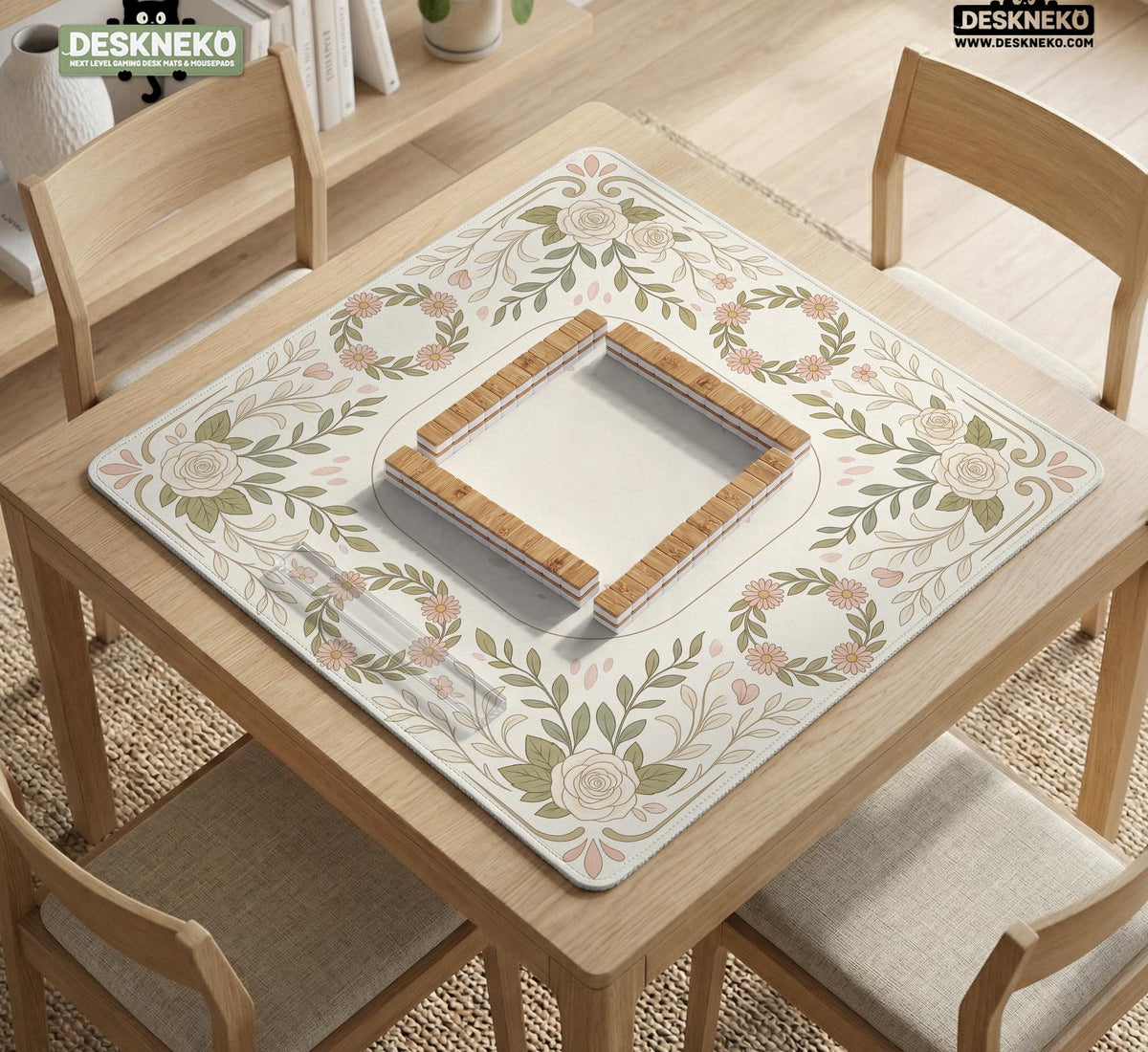 Square mahjong mat with a light floral border in sage green, cream, and blush around a plain center play area.