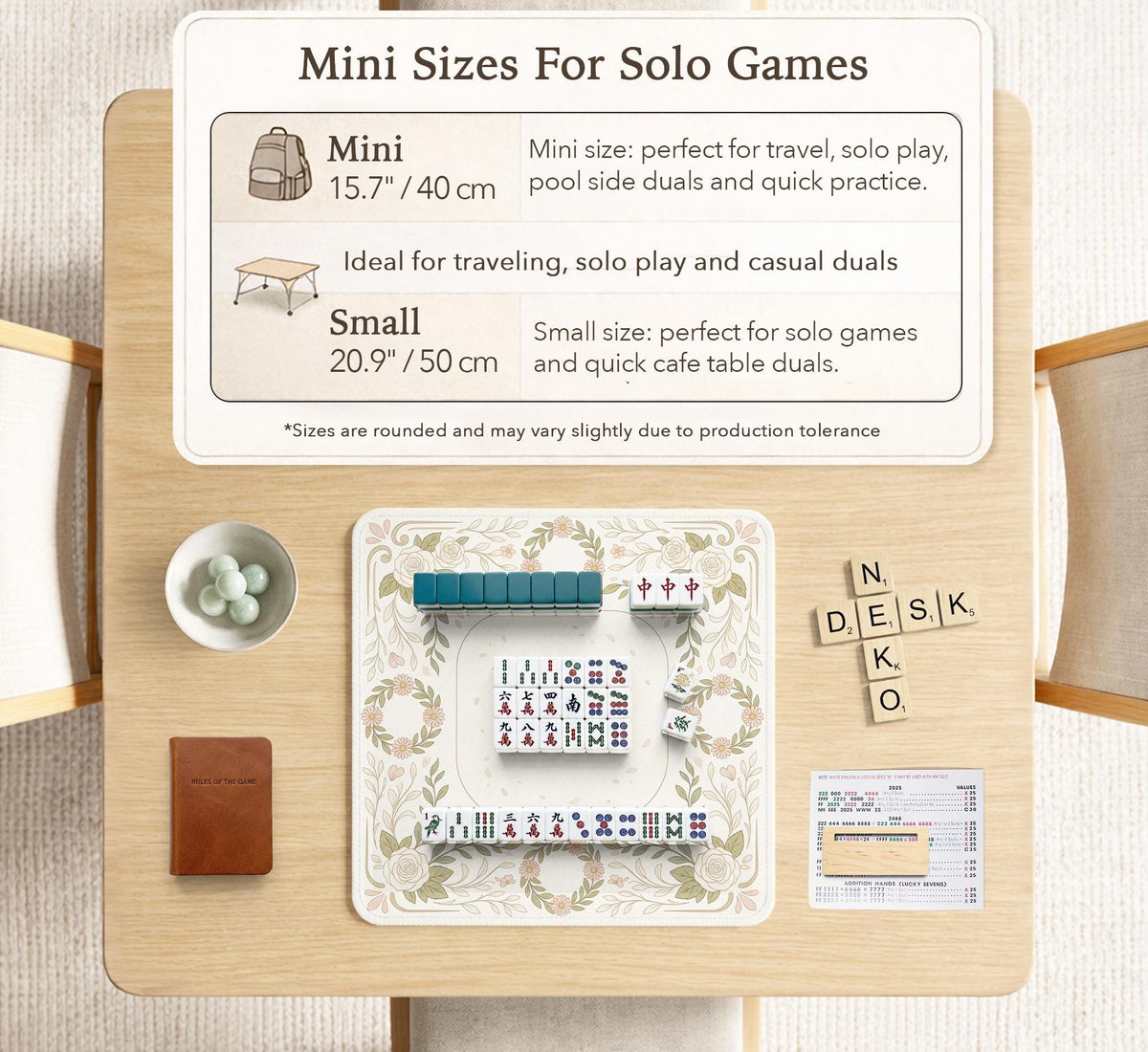 Square mahjong mat with a light floral border in sage green, cream, and blush around a plain center play area.