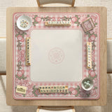 Pink gingham mahjong mat with a floral border, cherry blossom details, and a bow design around a plain center play area.