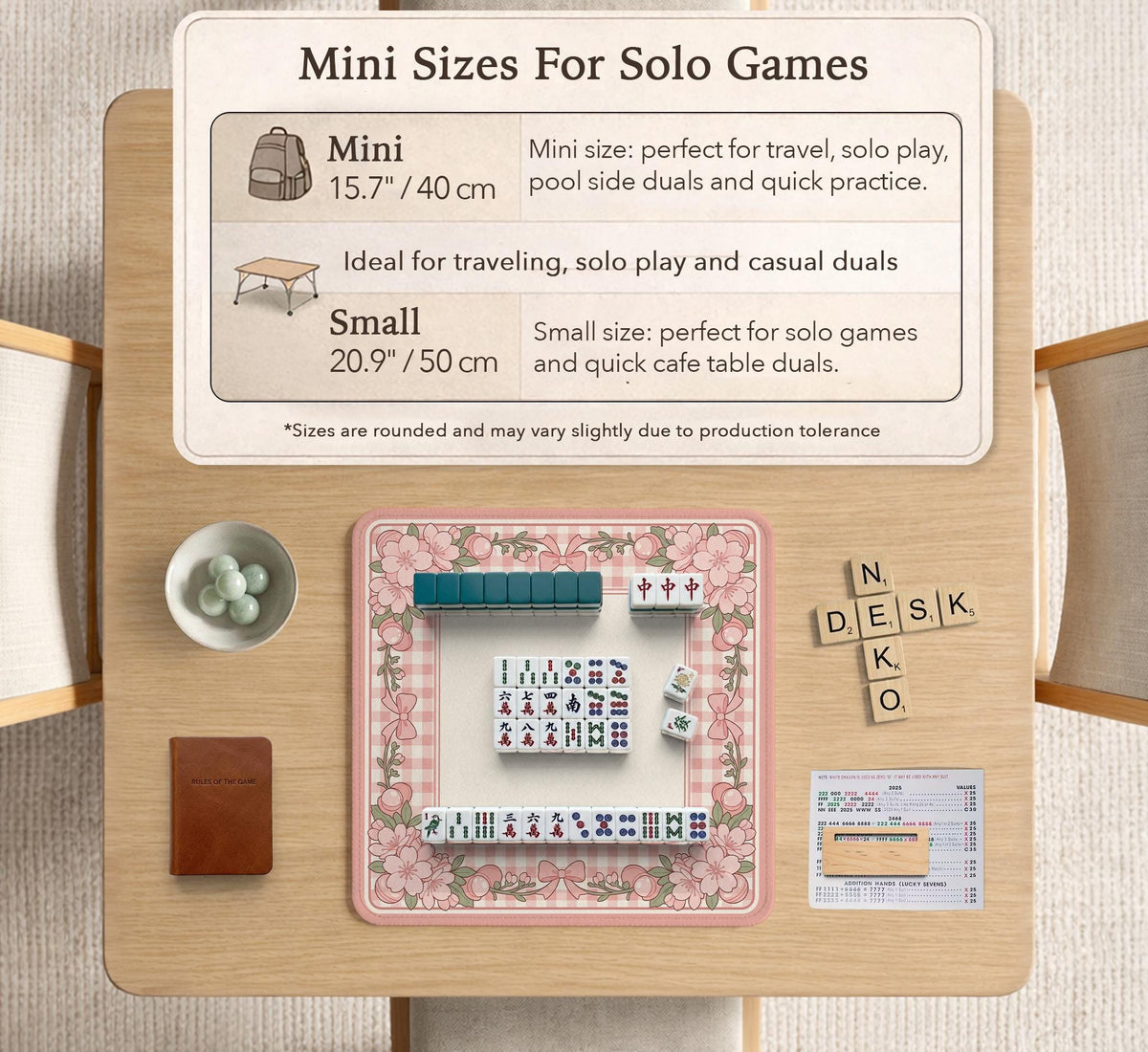 Square pink mahjong mat with a gingham border, floral corner details, and ribbon accents on a light background.