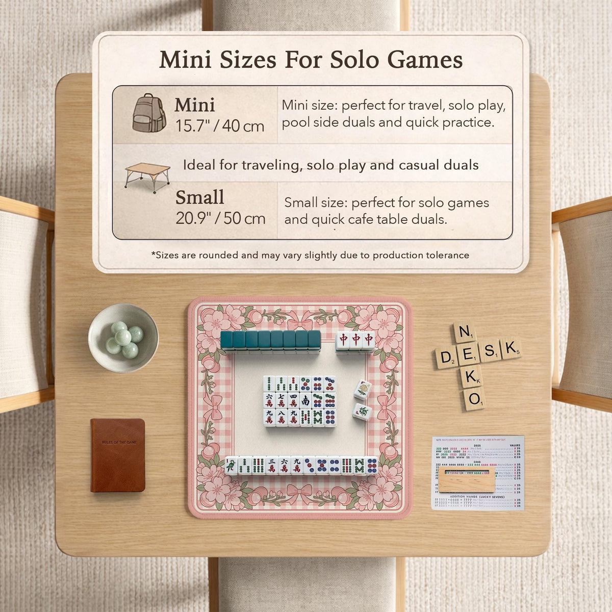 Square pink mahjong mat with a gingham border, floral corner details, and ribbon accents on a light background.