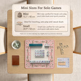 Square pink mahjong mat with a gingham border, floral corner details, and ribbon accents on a light background.