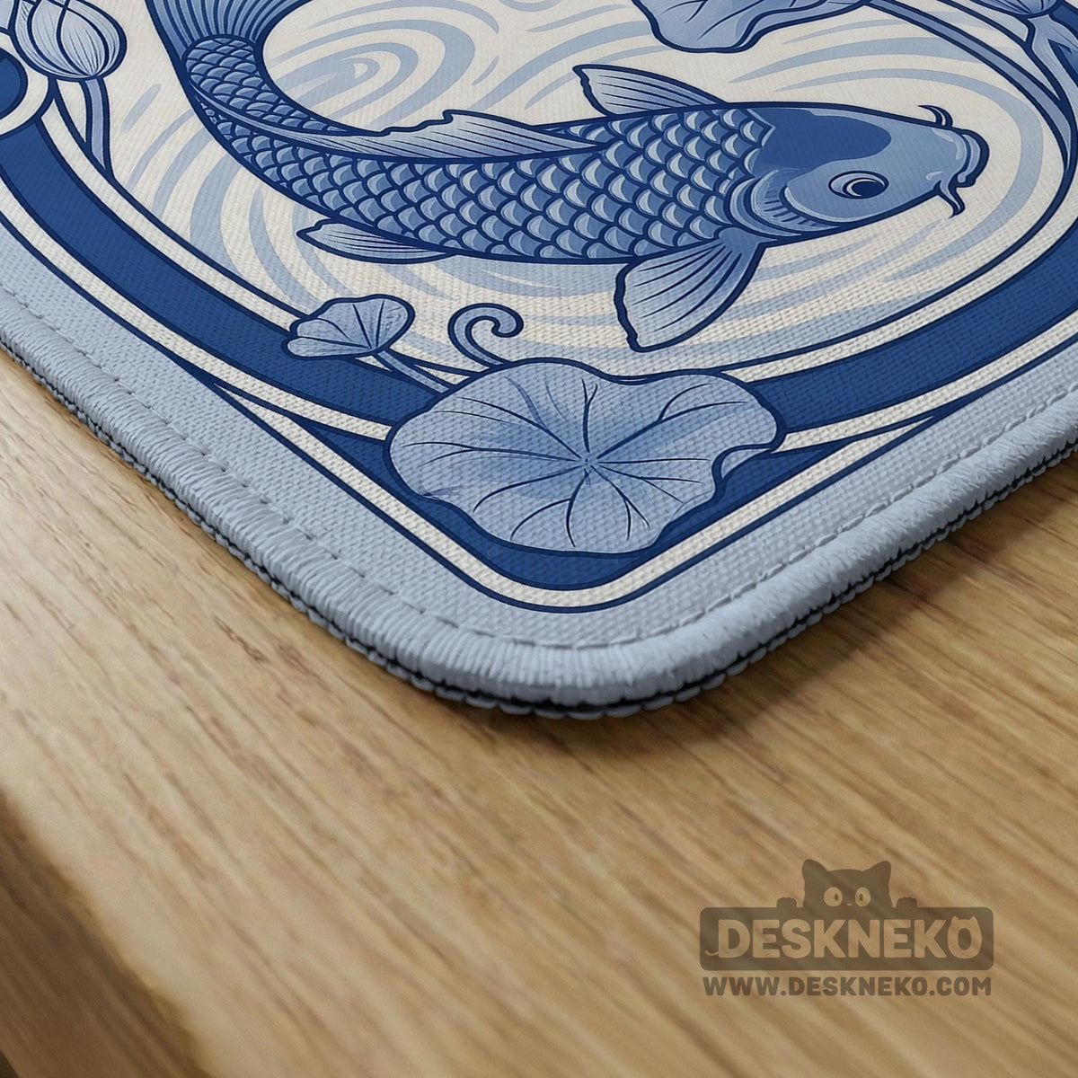 Blue and white square mahjong mat with a koi fish and lotus border design and a plain center area.