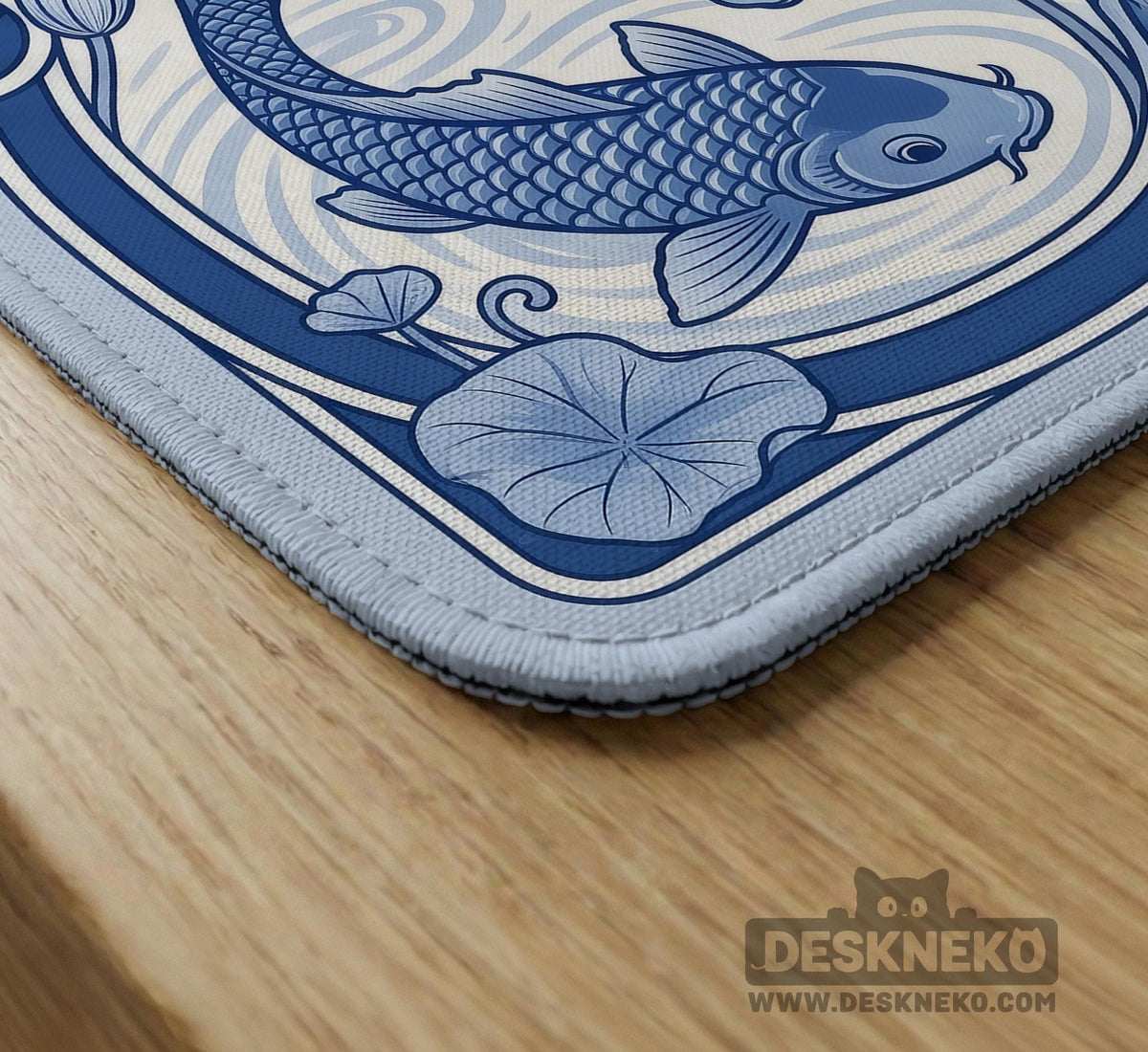 Navy blue square mahjong table mat with lotus flowers and koi fish in a porcelain-style border and a plain center.