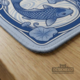Navy blue square mahjong table mat with lotus flowers and koi fish in a porcelain-style border and a plain center.