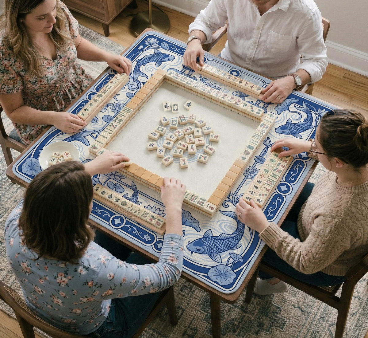 Blue and white square mahjong mat with a koi fish and lotus border design and a plain center area.
