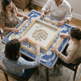 Navy blue square mahjong table mat with lotus flowers and koi fish in a porcelain-style border and a plain center.