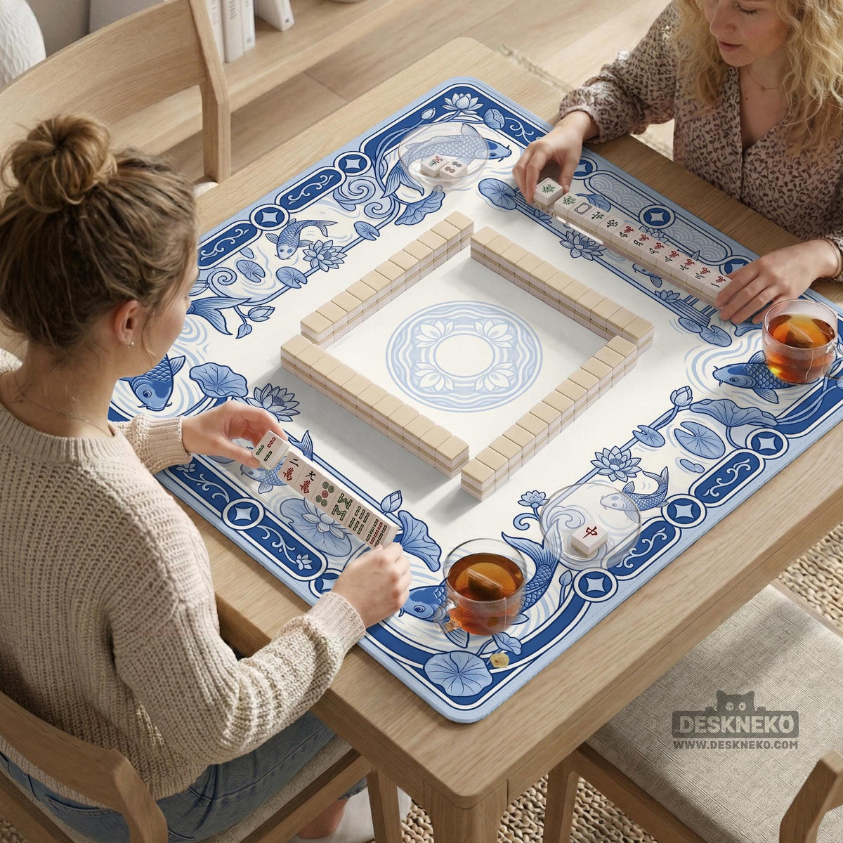 Blue and white square mahjong mat with a koi fish and lotus border design and a plain center area.