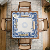 Blue and white square mahjong mat with a koi fish and lotus border design and a plain center area.