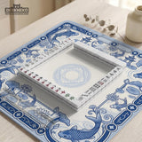 Blue and white square mahjong mat with a koi fish and lotus border design and a plain center area.