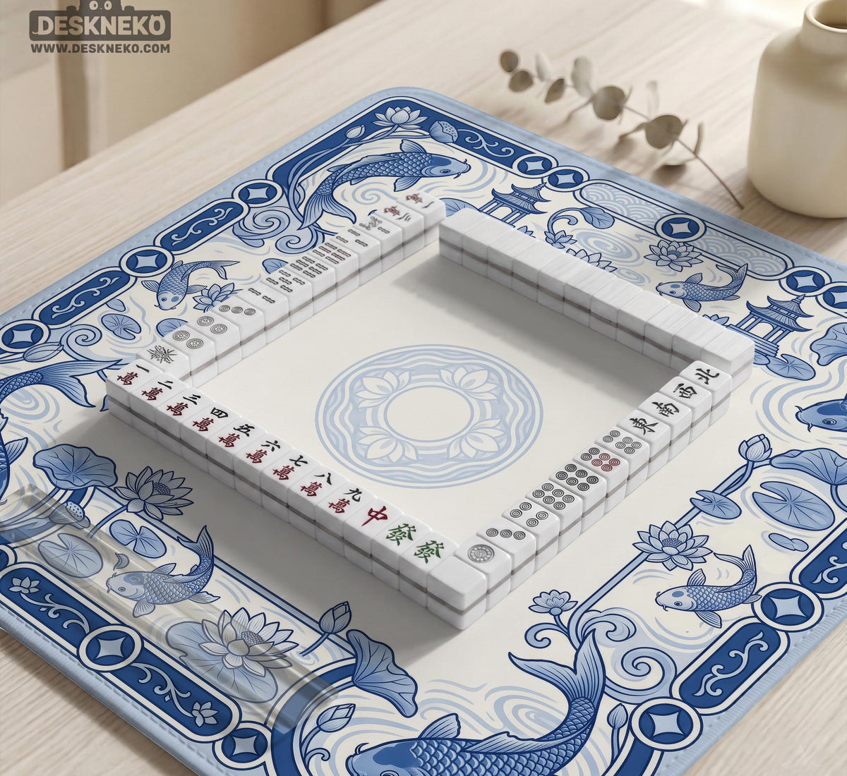 Navy blue square mahjong table mat with lotus flowers and koi fish in a porcelain-style border and a plain center.