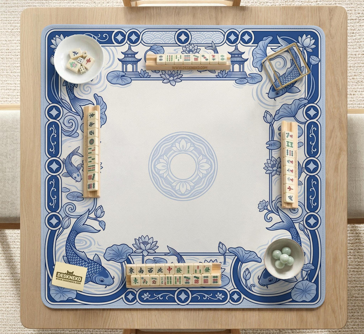 Blue and white square mahjong mat with a koi fish and lotus border design and a plain center area.