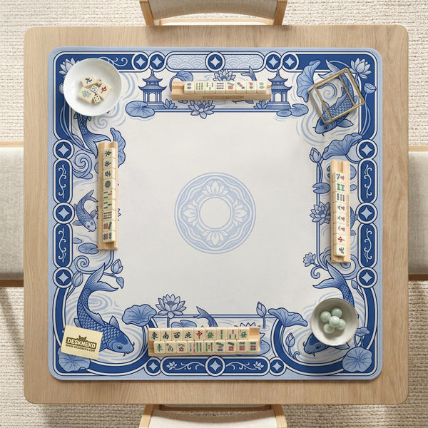 Blue and white square mahjong mat with a koi fish and lotus border design and a plain center area.