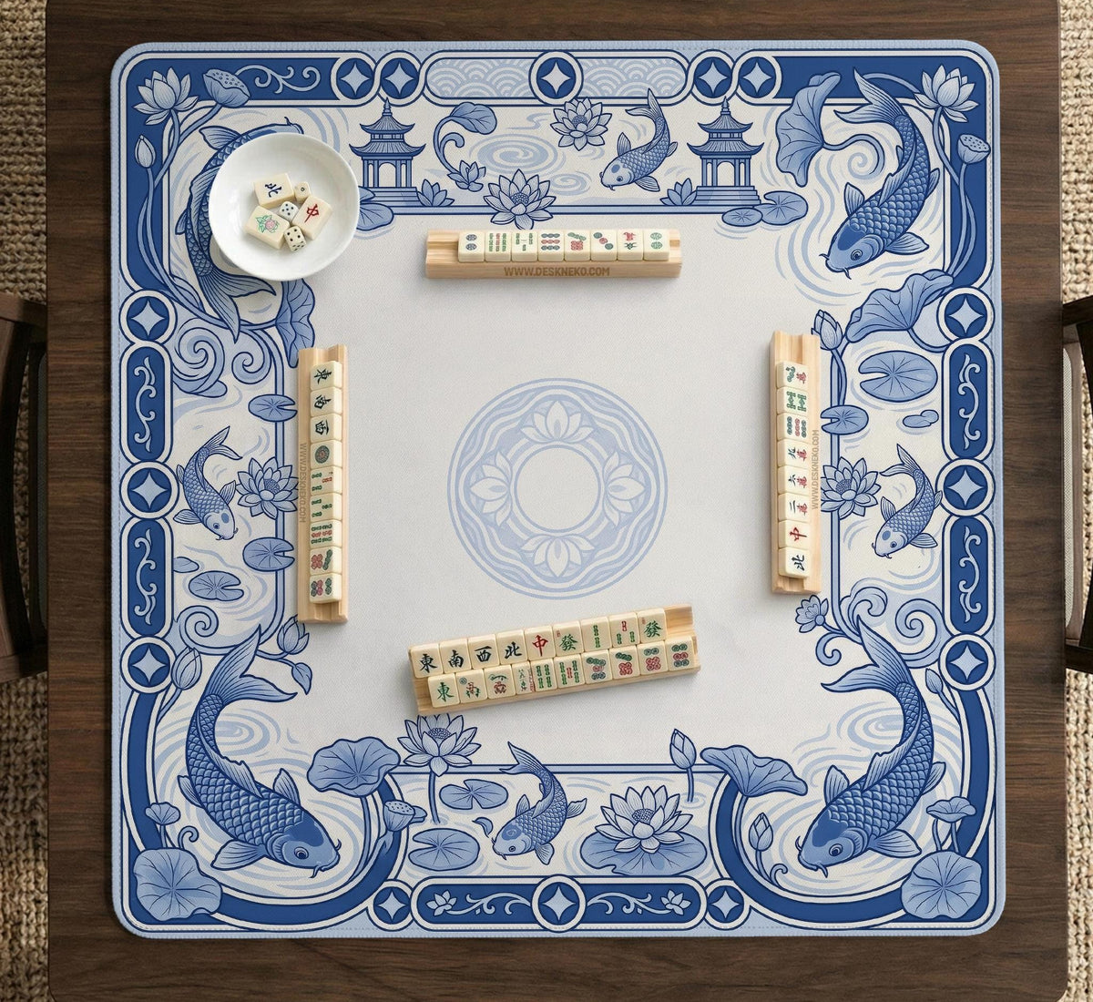 Blue and white square mahjong mat with a koi fish and lotus border design and a plain center area.
