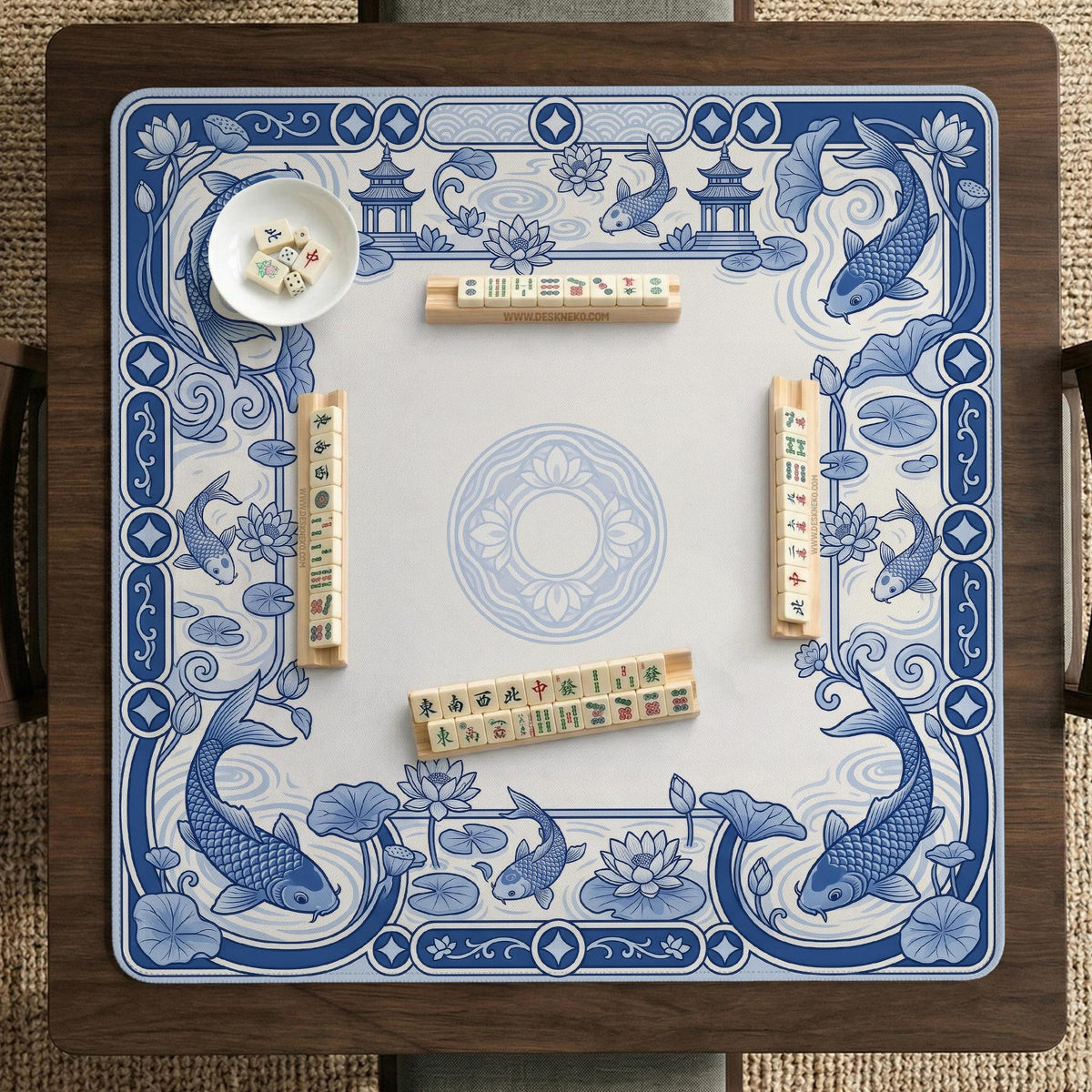 Navy blue square mahjong table mat with lotus flowers and koi fish in a porcelain-style border and a plain center.