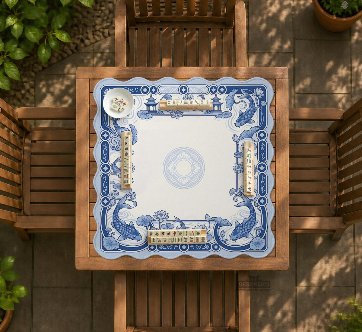 Blue and white square mahjong mat with a koi fish and lotus border design and a plain center area.