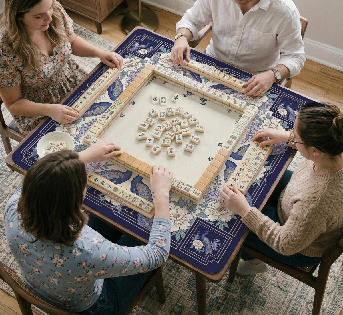 Blue mahjong table mat with a peacock and floral border, ivory center, lavender flowers, and scalloped edges.