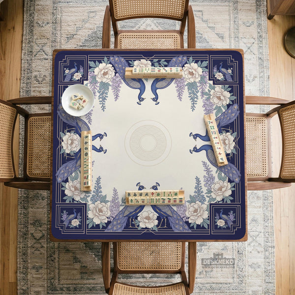 Blue mahjong table mat with a peacock and floral border, ivory center, lavender flowers, and scalloped edges.