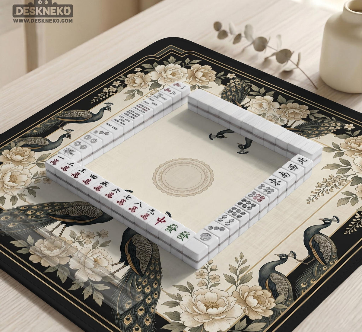 Square ivory mahjong mat with a black peacock border, cream flowers, and gold accent details.