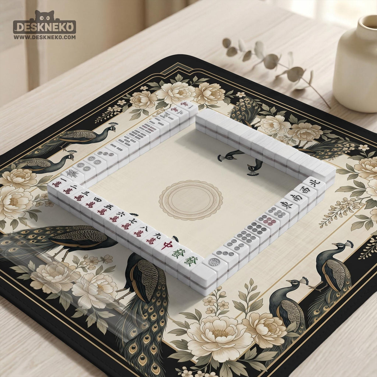 Square ivory mahjong mat with a black peacock border, cream flowers, and gold accent details.