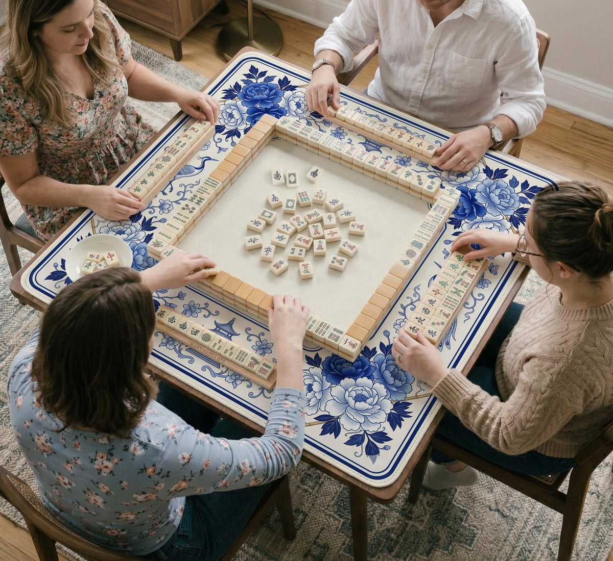 Square blue and white mahjong mat with peonies, cranes, pagoda accents, and chinoiserie linework around a plain center.