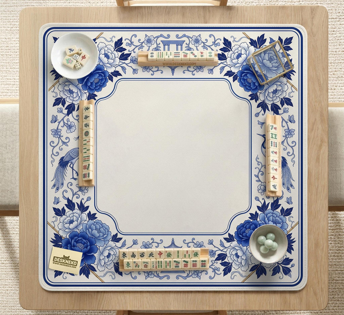 Square blue and white mahjong mat with peonies, cranes, pagoda accents, and chinoiserie linework around a plain center.