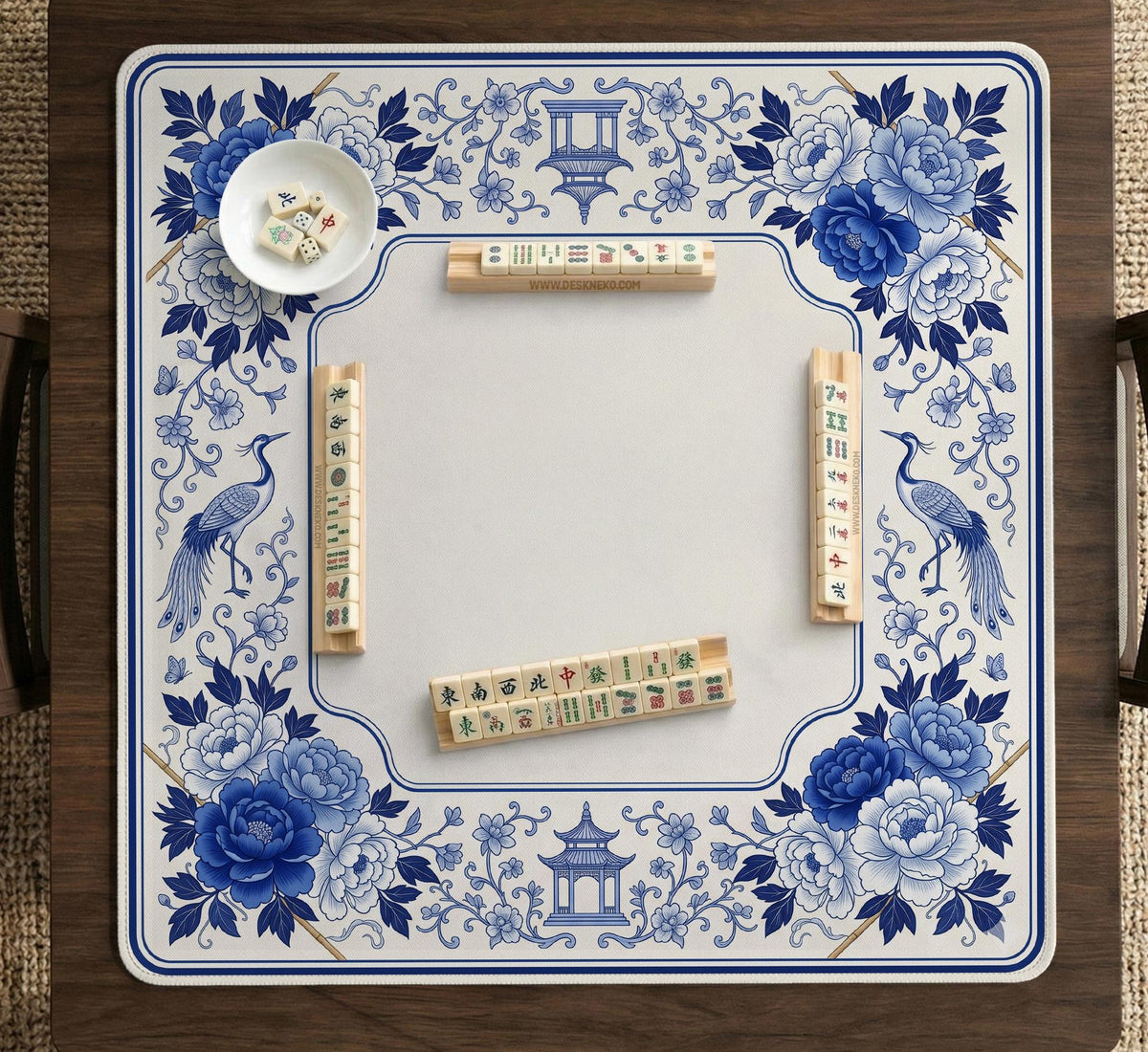 Square blue and white mahjong mat with peonies, cranes, pagoda accents, and chinoiserie linework around a plain center.