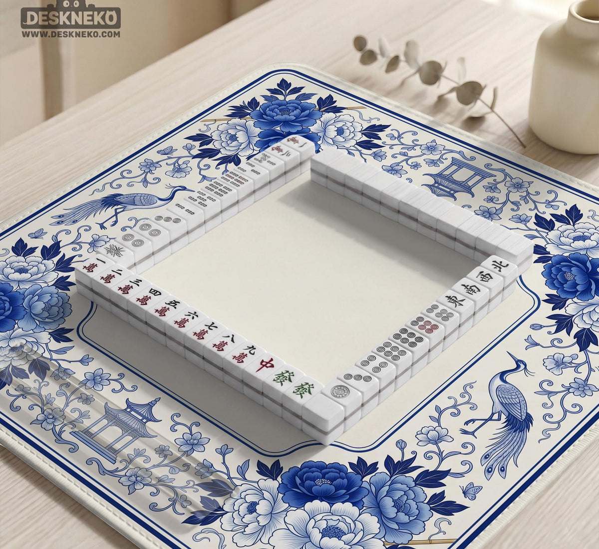 Square blue and white mahjong mat with peonies, cranes, pagoda accents, and chinoiserie linework around a plain center.