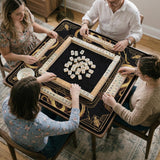 Square black mahjong mat with gold dragon artwork around the border and a light marble texture in the center.
