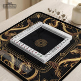 Black mahjong table mat with a gold dragon border, gold geometric corner details, and a clear center play area.