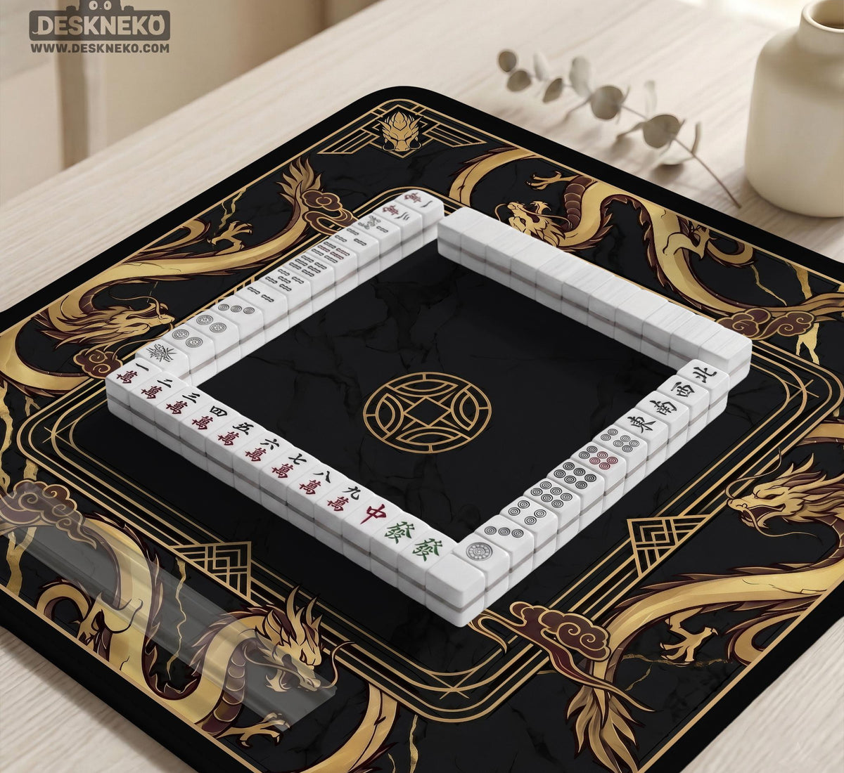 Square black mahjong mat with gold dragon artwork around the border and a light marble texture in the center.
