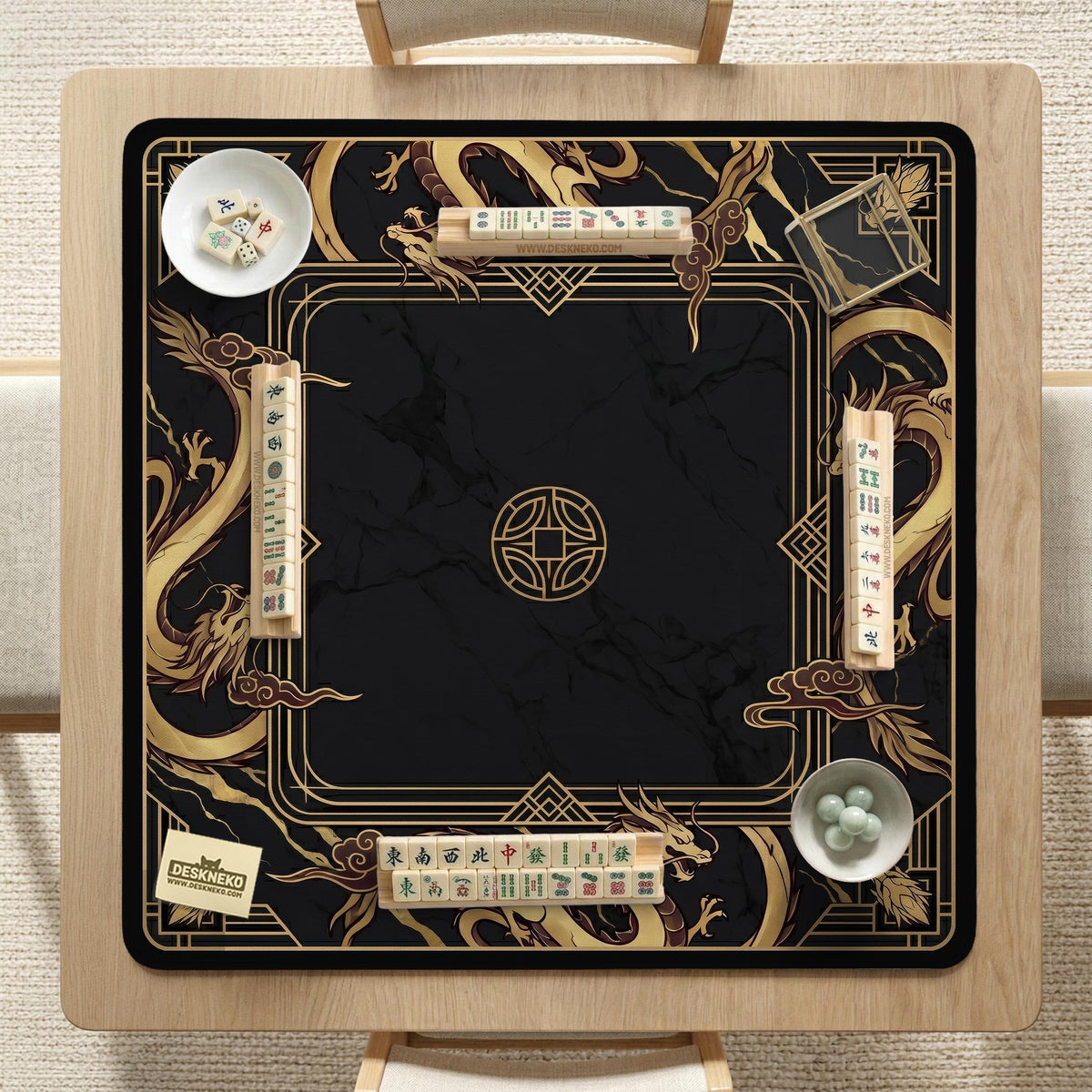 Square black mahjong mat with gold dragon artwork around the border and a light marble texture in the center.