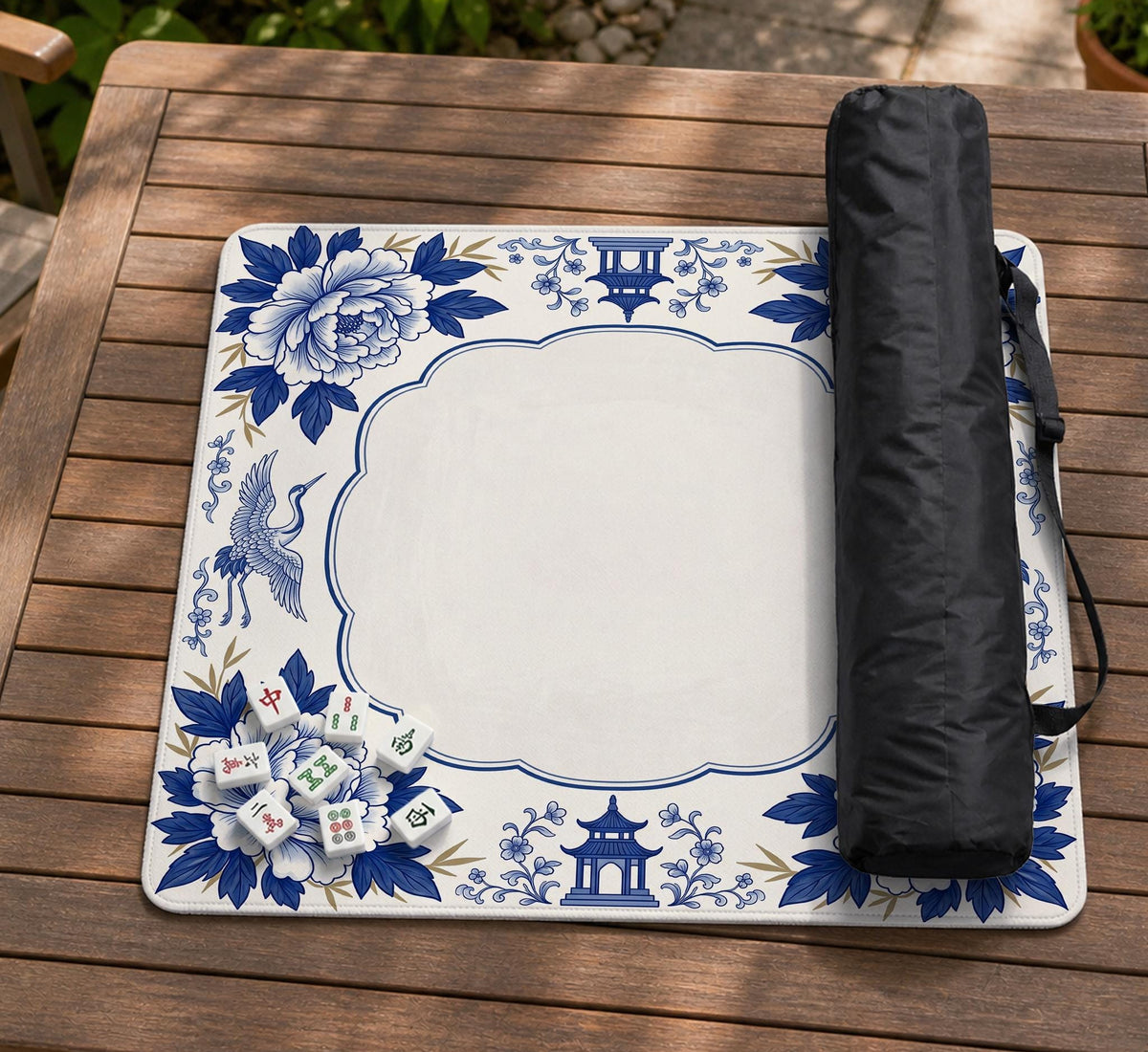 Blue and white mahjong mat with cranes, floral porcelain-style artwork, a cream center area, and a decorative border.