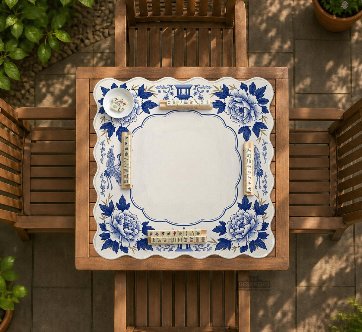 Blue and white mahjong mat with cranes, floral porcelain-style artwork, a cream center area, and a decorative border.