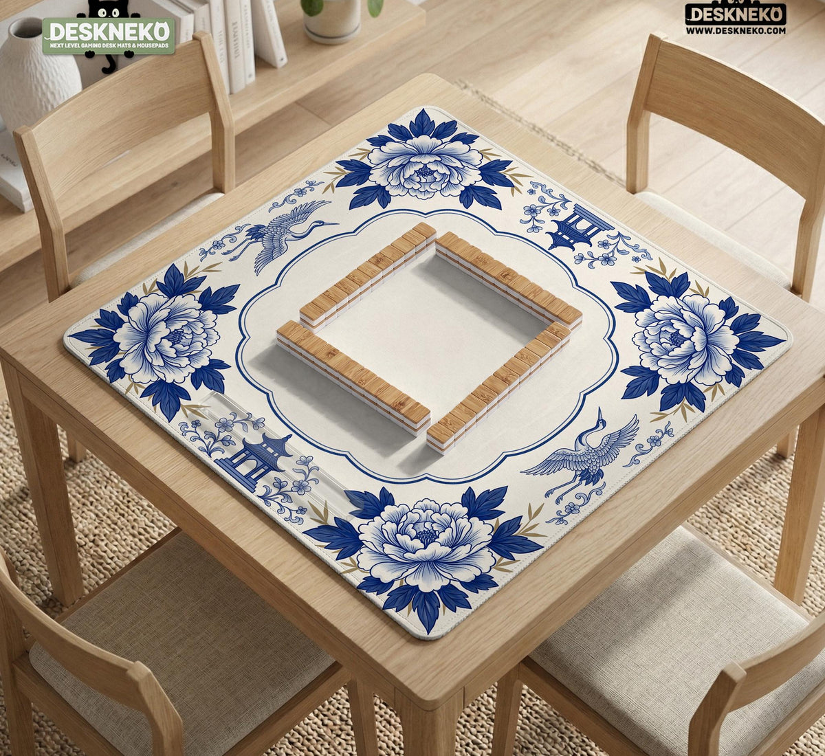 Blue and white mahjong mat with cranes, floral porcelain-style artwork, a cream center area, and a decorative border.