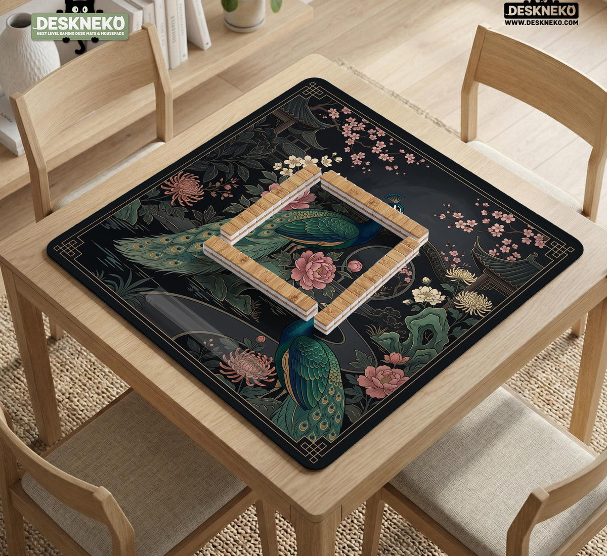 Square black mahjong mat with a gold peacock, blush flowers, and dark botanical artwork on a dark background.
