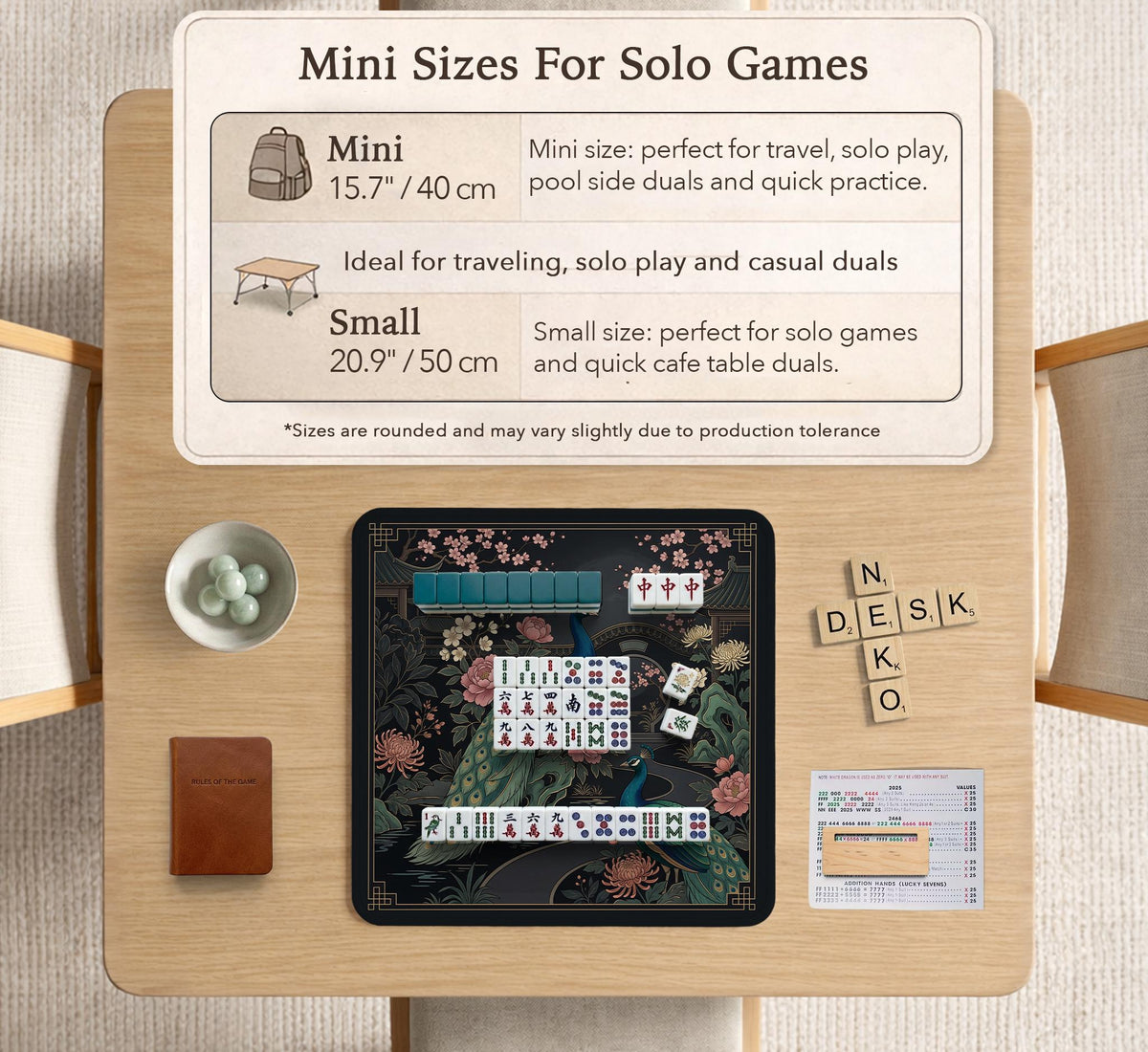 Square black mahjong mat with a gold peacock, blush flowers, and dark botanical artwork on a dark background.