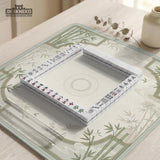 Square light green mahjong mat with bamboo stalks, soft ivory details, botanical shadows, mist lines, and a circular center design.