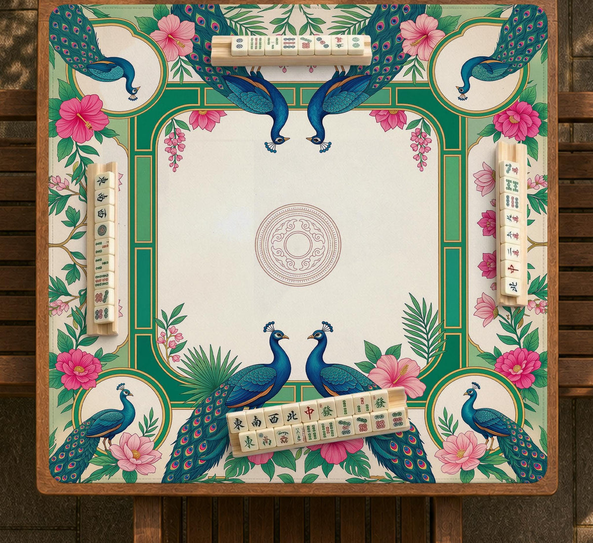 Green mahjong mat with peacocks, hibiscus flowers, tropical leaves, cream center space, and a scalloped floral border.